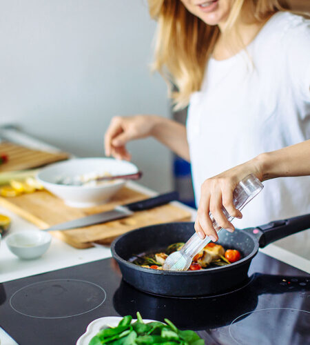 a woman cooks a meal at home