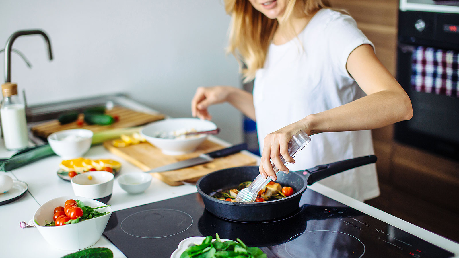 a woman cooks a meal at home